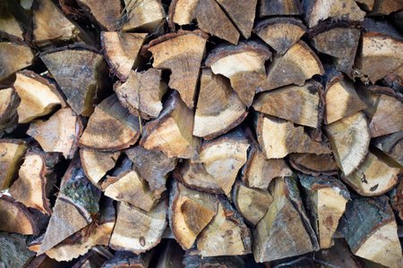 Woodpile with chopped wood. Procurement of fuel for the winter.