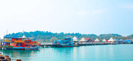 Fishing and pleasure boats moored to the pier on the sea. Travel and tourism in Thailand.の写真素材