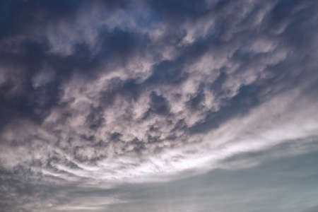 Dark dramatic clouds in the evening sky. Thunderclouds in bad weather. Atmospheric mood. Background...