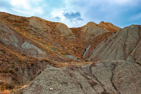 Mountain hills against the sky on a cloudy autumn day.
