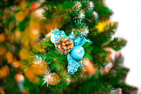 Christmas tree with festive decorations and yellow bokeh from garlands. Celebrating New Year and Christmas.の写真素材