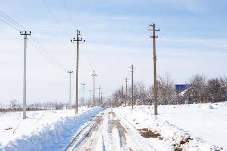 The country road is cleared of fallen snow on a sunny winter day.の写真素材