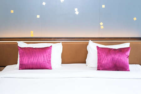 Large king size bed with burgundy pillows. Comfortable bed and good sleep.の写真素材