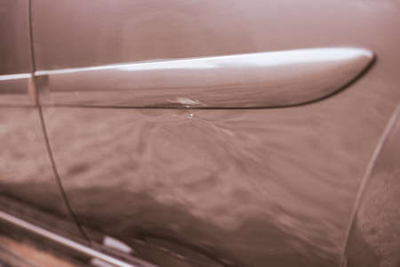 Dent with a scratch on the car door after the accident. Accident and car repair.