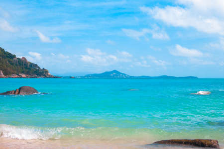 Sea bright landscape. Azure sea and stones in the water on a sunny day. Wallpaper, postcard, travel concept.の写真素材