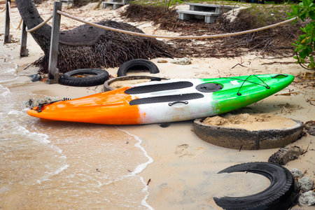 Board for riding on the water with a paddle on the seashore. Leisure and entertainment on vacation.の写真素材