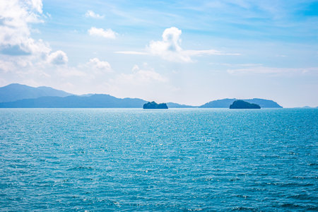 Seascape. Small islands in the sea with a mountainous coast.の写真素材