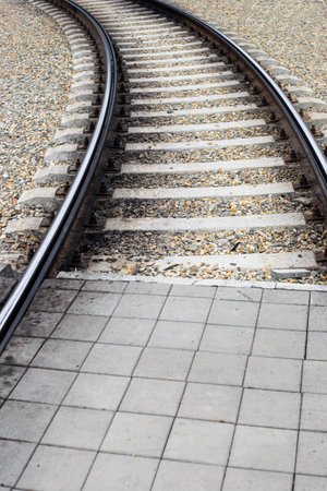Streetcar line with a platform for pedestrians to cross. The rails go into the distance.の写真素材