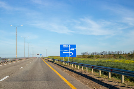 Road with a sign and an inscription of the direction of movement and cities.の写真素材