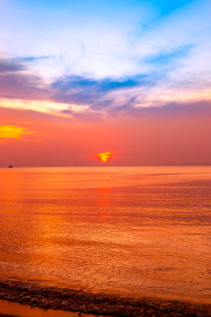 Sea coast with orange sunset. beautiful vertical seascape.の写真素材
