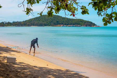 A fisherman pulls fishing nets from the sea. Fishing in Thailand.