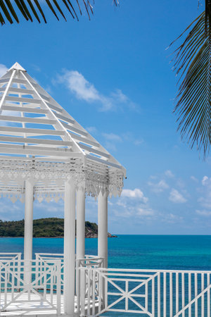 White carved gazebo on the seashore in a tropical country. Holidays in Asia.の写真素材