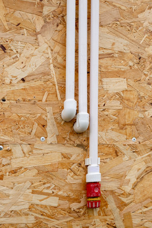 Water supply polypropylene pipes on a wooden wall surface. Installation of plumbing for a summer...