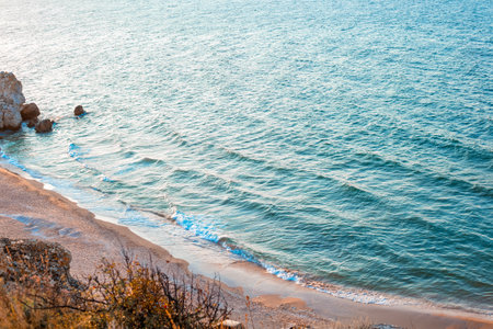 Seascape. Blue sea with rocky shore and sandy beach. View from the mountain.の写真素材