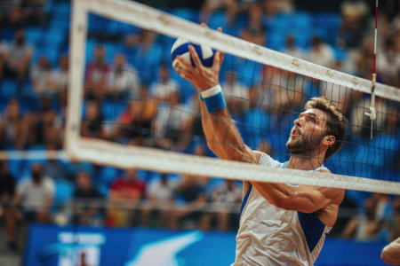 Olympic men's volleyball tournament. a man near the net scores a ball.の素材