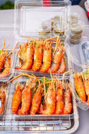 Street food. Grilled shrimp in a package at a night market in Asia.の写真素材
