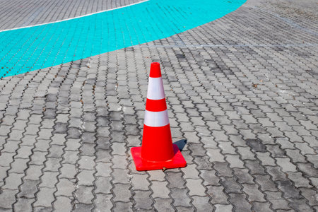 Traffic cone on paving stones. Traffic restriction.の写真素材