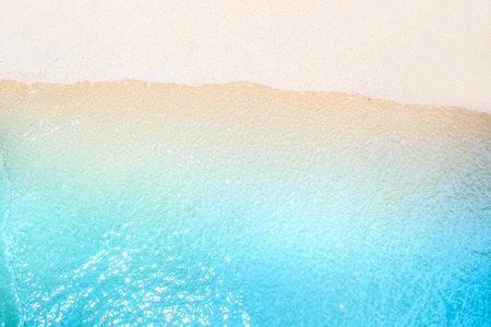 Transparent blue sea water on sandy shore, top view. Beautiful natural background for text, travel and tourism.の写真素材