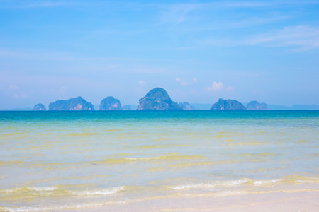 Seascape. Sandy seashore with azure water and islands in the sea on the horizon in Krabi province Thailand.の写真素材