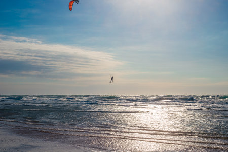 Seascape. Kitesurfer with a parachute over the water. Active sports recreation.の写真素材