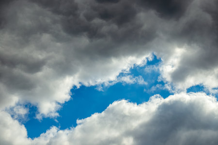 Dramatic sky. Dark cloudy sky with a light interval of clear blue sky.