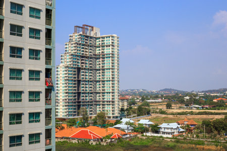 Urban architecture in asia. High rise buildings surrounded by greenery and villas, high angle shot.の写真素材