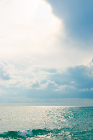 Marine vertical landscape. Beautiful sea with wave and sky with clouds on a cloudy autumn day.