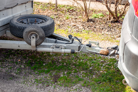 A car hitch is connected to a trailer whose spare tires are attached to the trailer frame.の写真素材