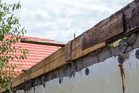 Concrete wall with wooden formwork on top, construction of reinforced concrete belt, wall repair, preparation for installation of maurlat.の写真素材