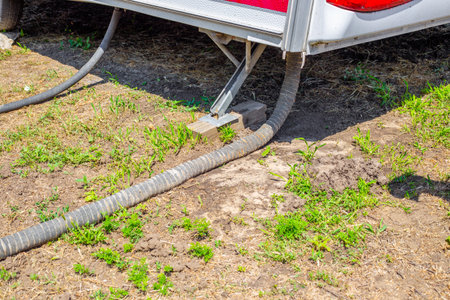 On the bottom of the camper, a connection between hoses and support structures on the ground. sewage system.の写真素材