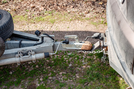 A car hitch is connected to a trailer whose spare tires are attached to the trailer frame.の写真素材