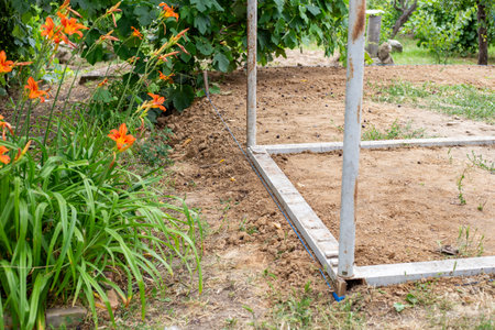 corner of aluminum frame foundation of greenhouse or gazebo under construction in the garden.の写真素材
