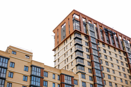 Modern high-rise residential buildings with varied facades rise, showing contemporary urban...