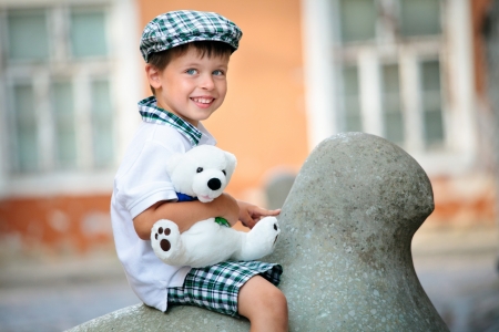 Close up portrait of happy little boy outdoors in city on beautiful spring day の写真素材