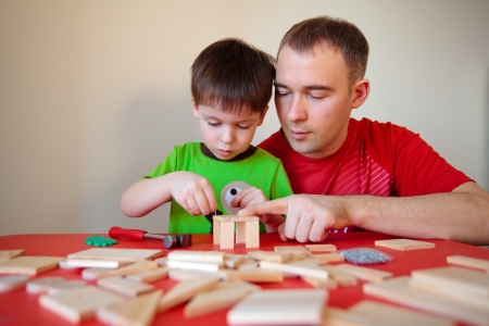 Happy family  Father and son working at homeの写真素材