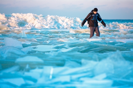 Man walking on icy beach along the Baltic sea in Latvia, Jurmalaの写真素材