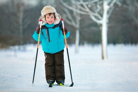 Cute five years old boy skiing on crossの写真素材