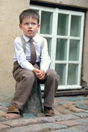 Portrait of a cute four years old boy outdoors in city の写真素材