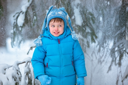 Cute little boy playing outdoors in a forest の写真素材