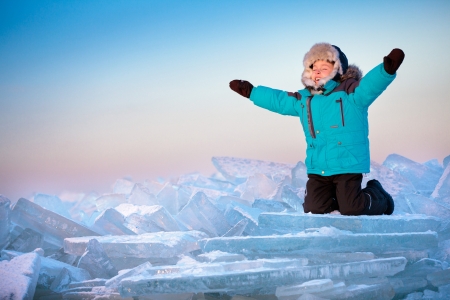 Cute little boy on beach on cold winter dayの写真素材