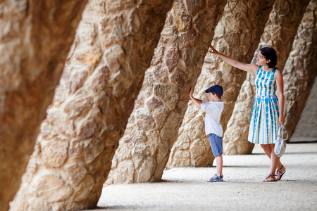 Young mother and her son walking Park Guell, Barcelonaの写真素材