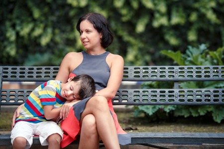 Portrait of mother and son sitting outdoors
