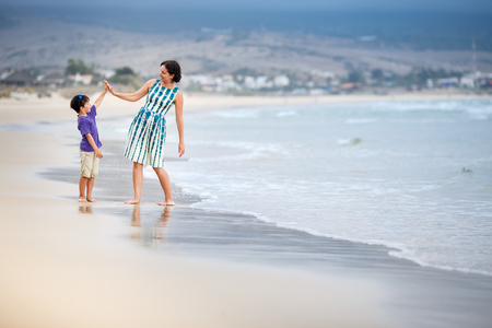 Mother and son having fun during beach vacationの写真素材