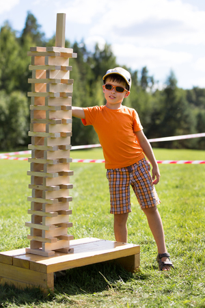 Cute little boy with wooden tower gameの写真素材