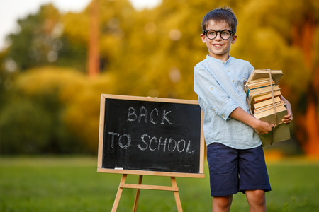 Cute little schoolboy feeling excited about going back to school