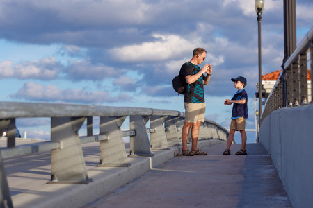 Young father and son on Fort Lauderdale Bridge, Florida, USAの写真素材