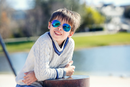 Cheerful little boy having relax outdoors during his summer vacationの写真素材