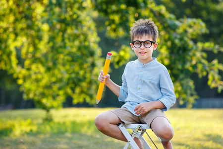 Cute little schoolboy feeling extremely excited about going back to school