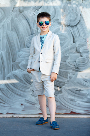 Little boy in a nice suit and glasses. Back to school. Children portrait. Stylish kid in suitの写真素材