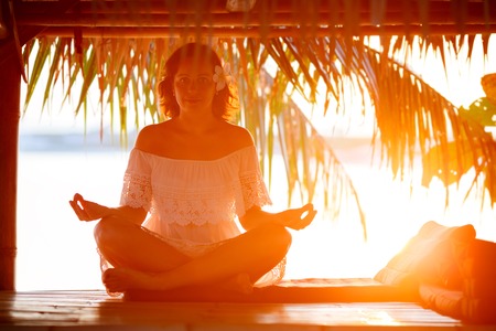 Young woman doing yoga outside in natural environmentの写真素材